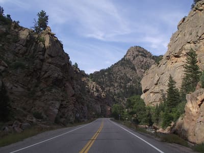 Colorado 7 winding between red sandstone walls in the South St. Vrain canyon