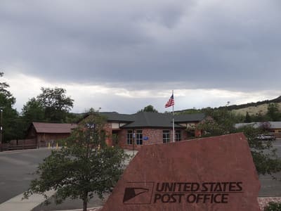 The red-roofed Lyons post office, flag flying