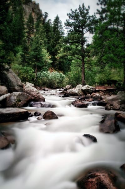 The North St. Vrain pouring white between red boulders in the canyon above Lyons